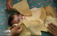 تصاویری از نذر نان پوشی,عکس های نذر نان با کودکان,تصاویر پوشاندن سر تا پای نوزاد را با نان